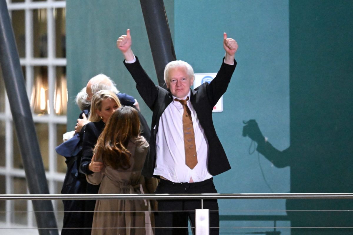 WikiLeaks founder Julian Assange gestures after landing in Canberra, Australia, on Wednesday. (Rick Rycroft / Associated Press)