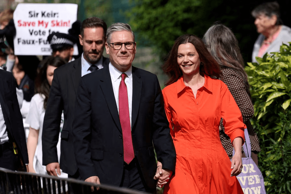 Britain's opposition Labour Party leader Keir Starmer and his wife Victoria Starmer walk outside a polling station during the general election in London, Britain, July 4, 2024. Credit: Reuters/ Claudia Greco