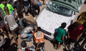 Palestinians examine the wreckage of a car following an Israeli airstrike in Mawasi on Tuesday. Credit: Haitham Imad/EPA