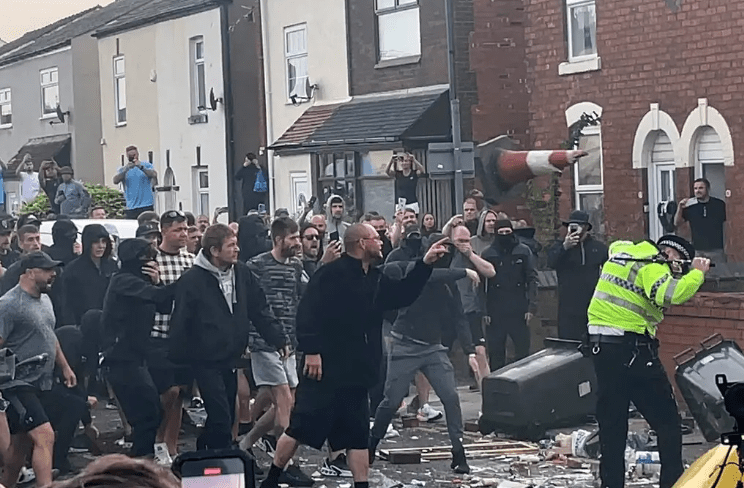 A crowd clashed with the police after a vigil near the site of the stabbing attack in Southport on Tuesday. Credit: AP