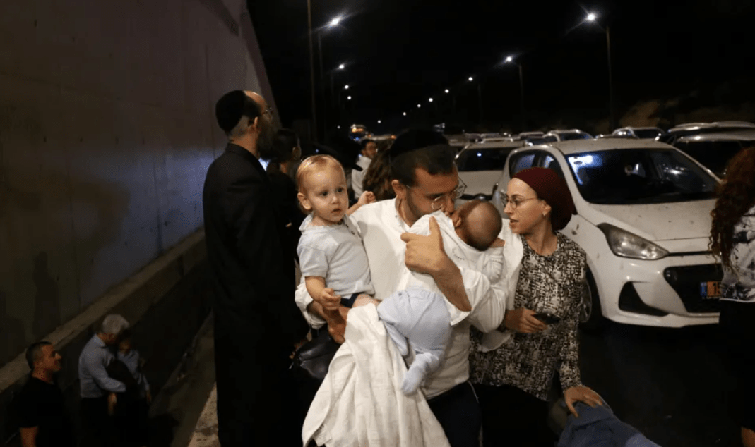 Israelis flocked to safety after the attack. Credit: Reuters.