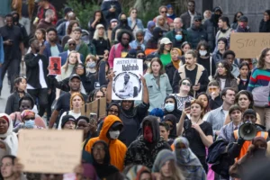 Chants of “no justice, no peace” and “compassion not bullets” echoed through the Footscray CBD as the crowd marched to the local police station, calling for systemic reform, greater mental health support, and an independent inquiry into the fatal shooting. Credit: Nine