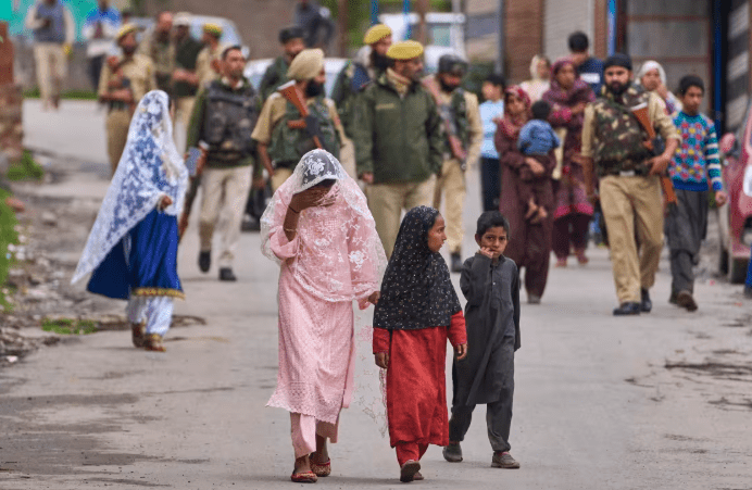 Police assist Kashmiri villagers as they evacuate their homes after cross-border shelling overnight in the region near the Pakistan border, May 9. Credit: Associated Press